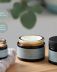 Three jars of MAYDI+ rejuvenating night cream on a wooden surface with greenery in the background.