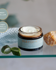 Maydi rejuvenating night cream jar on a glass surface with decorative elements
