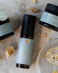 Maydi+ skincare products including a serum, cream, and night cream on a textured surface with natural ingredients.