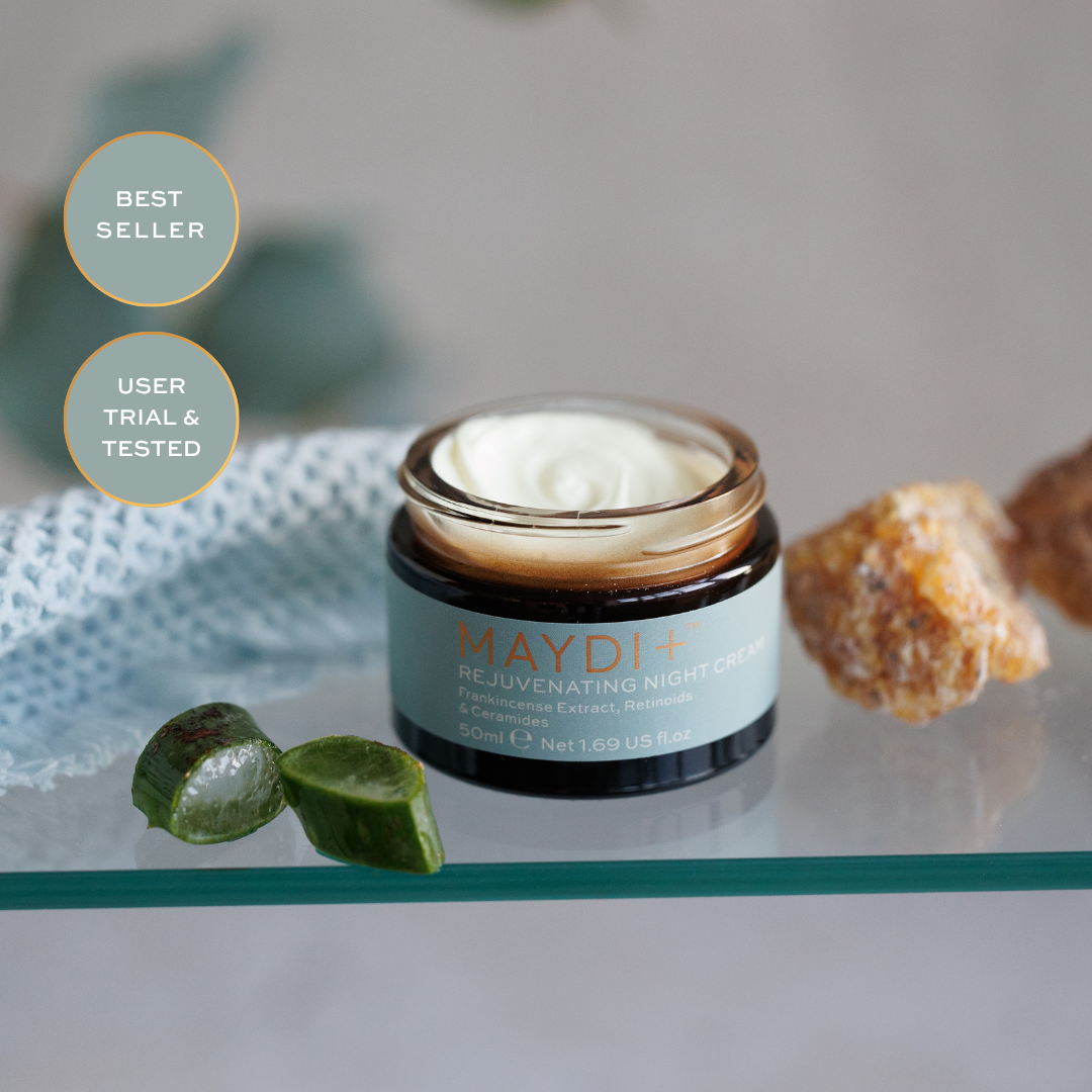 Maydi rejuvenating night cream jar on a glass surface with decorative elements