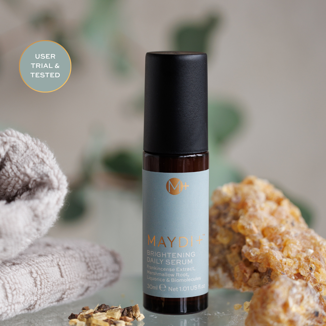 Maydi brightening daily serum bottle with natural elements in the background